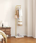 Gold Metal Coat Rack With 3 Hooks, L Shaped Freestanding Coat Tree in bedroom corner with wood base and hanging clothes.