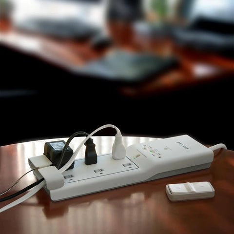 8 Outlet Conserve Switch Surge Protector With Remote, 4ft Cord, White Power Strip For Computer Desk Setup shown on table with devices.