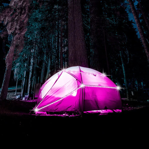 Camping tent lit with Battery Powered LED Strip Lights 13ft USB And Battery Operated RGB Color Changing LEDs in a forest.