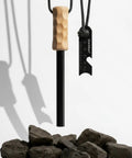 Ferro Rod Fire Starter Survival Tool With Hardwood Handle, Waterproof Camping Essentials, Up To Twenty Thousand Strikes shown with rocks