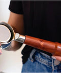 Level Up Your Home Barista Setup With This 58mm Bottomless Portafilter For Breville Dual Boiler Oracle Espresso Machine Rosewood Handle held in hands.