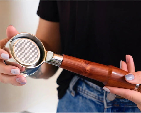 Level Up Your Home Barista Setup With This 58mm Bottomless Portafilter For Breville Dual Boiler Oracle Espresso Machine Rosewood Handle held in hands.