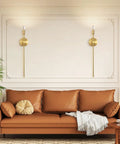 Sleek Gold Wall Candle Sconces Set Of Two Large 23 Inch Modern Light Fixtures For Bedroom Dining Room And Living Room Chic Home Decor That Delivers Major Flex Ambiance Always, displayed beside a brown sofa.