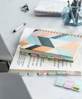 Sweet Repositionable Sticky Tabs For Books And Notes Durable Page Markers In Blue Green Yellow And Red Simple To Swap on a notebook.