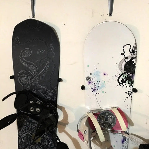 Minimalist Snowboard Wall Mount Display Rack Featuring Felt Padded Arms And Durable Rubber Grip To Stash Your Sick Ride Securely In Garage Or Home Studio And Recreation Room with two boards
