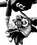 Angler handling Exist LT Spinning Reel with Lightweight MQ Body, ZAION Construction, Airdrive Rotor and Spool for smooth casting