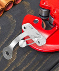 Silver lightweight epee socket replacement for fencing practice gear next to red tool on wooden surface