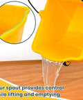 Close-up of yellow 35 Quart Side Press Wringer Mop Bucket Set On Wheels With Industrial Mop pouring water on floor