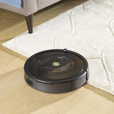 Robot vacuum on hardwood floor next to white rug, compatible with Replacement Kit for 800 and 900 Series Robot Vacuums with 3 AeroForce Filters.