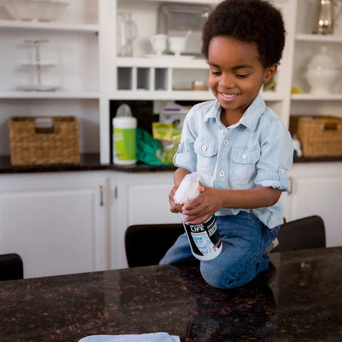 Child holding Granite Cleaner And Polish For Marble Quartz Slate And Concrete Surfaces Streak Free Stone Countertop Cleaner