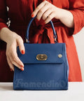 Framendino blue pebbled leather handbag with gold turn-lock clasp and top handle