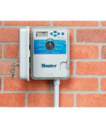 Mounted XC 600 Hybrid Battery Powered Irrigation Controller With Six Zone Sprinkler Timers on red brick wall