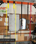 Rugged 2 Ton Telescoping Gantry Crane Portable Shop Lift Frame With Adjustable Boom Height and Locking Caster Wheels, 4,000 lb capacity, in garage setup.