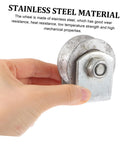 Close-up of cast-iron V-type groove wheel garage door caster with mounting plate and bolt, held in hand