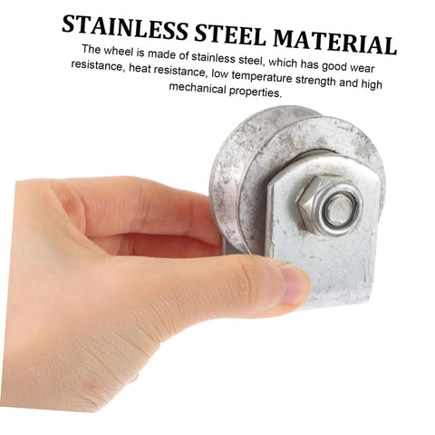 Close-up of cast-iron V-type groove wheel garage door caster with mounting plate and bolt, held in hand