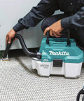 Person using XCV11Z 18V LXT Brushless Cordless 2-Gallon HEPA Wet Dry Dust Extractor Vacuum for carpet cleaning