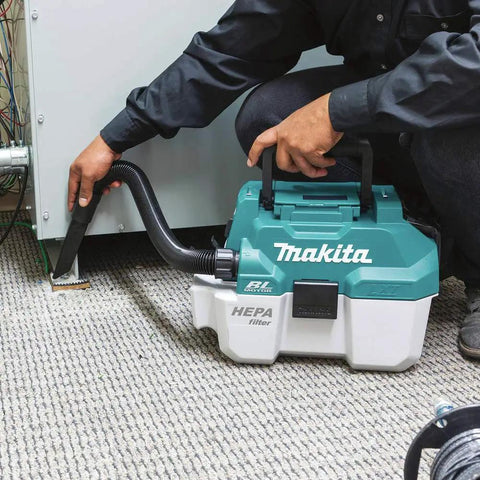 Person using XCV11Z 18V LXT Brushless Cordless 2-Gallon HEPA Wet Dry Dust Extractor Vacuum for carpet cleaning