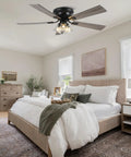 52 Inch Flush Mount Farmhouse Ceiling Fan With Remote And Reversible Wood Blades above a bed in a stylish bedroom setting.