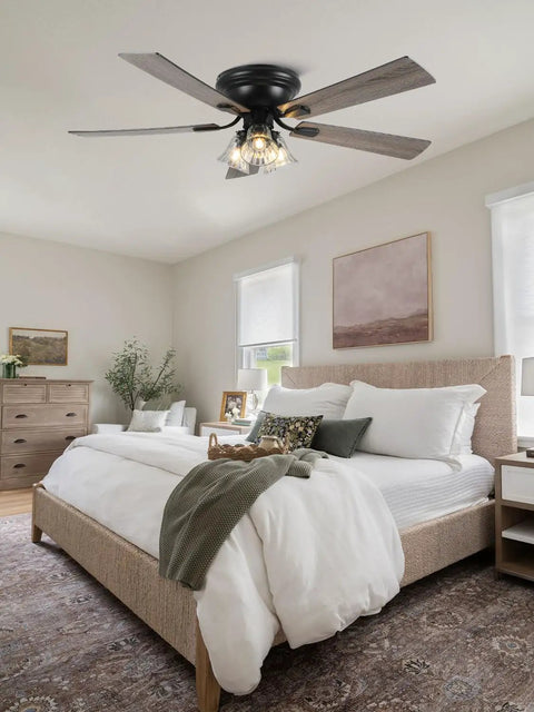52 Inch Flush Mount Farmhouse Ceiling Fan With Remote And Reversible Wood Blades above a bed in a stylish bedroom setting.