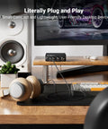 Q4 DAC Headphone Amp For PC And Home Audio Setup With USB Optical Coaxial Inputs, 3.5mm Headphone Output And RCA Speaker Outputs, Plug And Play Desktop Digital To Analog Converter For Richer Music, Gaming, And Movies on desk with headphones