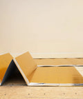 Premium Flooring Underlayment Roll 100 Sq Ft 2Mm Thick With PreTaped Sides Fan Fold Grid Cut Design laid out on the floor.