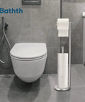 Brushed Nickel Free Standing Toilet Paper Holder Stand with space for one in use roll and three spare rolls in modern bathroom.
