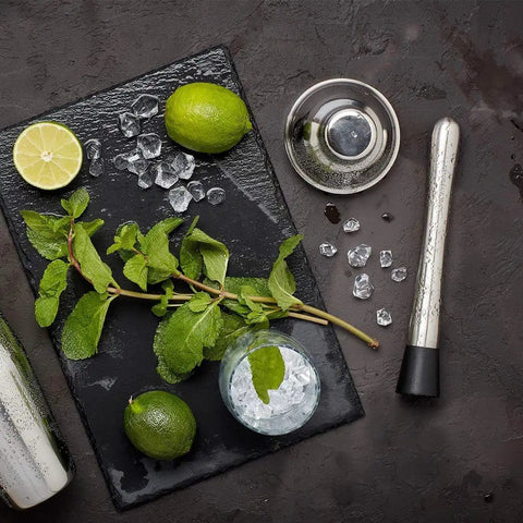 Food Grade 304 Stainless Steel Cocktail Muddler And Mixing Spoon Set for home bar with mint, lime, and ice on slate board.