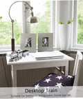 Retro Steam Locomotive Desk Decor for Home Office on a white desk near a window, silver model train with stars blanket on chair