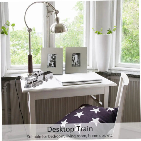 Retro Steam Locomotive Desk Decor for Home Office on a white desk near a window, silver model train with stars blanket on chair