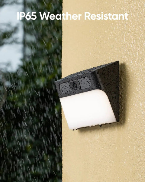 All In One Solar Wall Light Camera With 8GB Storage For Outdoor Security, installed on wall in rain, showcasing IP65 weatherproofing.