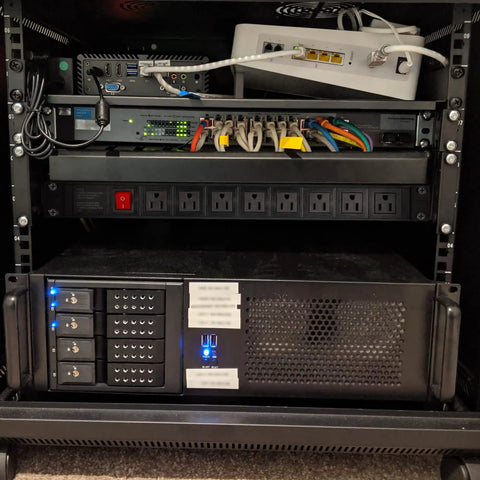 Eight Wide-Spaced Rack Mount Power Strip Surge Protector PDU installed in server rack with network devices, heavy duty use.