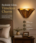 QUOLM Vintage Bronze Wall Sconce, Scalloped Uplight Wall Lamp, E26 in a cozy bedroom with warm ambient light.