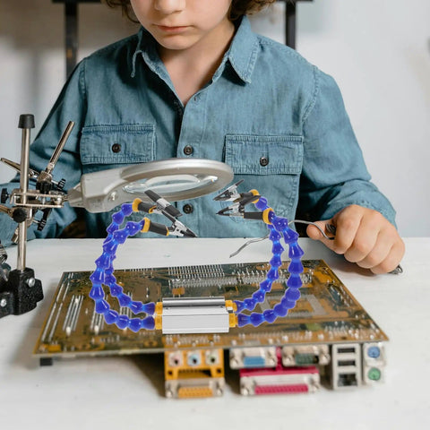 Child using Four Arm Soldering Helping Hand Station Pro Grade With Weighted Base for DIY PCB repair and electronics soldering.