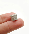 Hella Sparkling Diamond Charm Spacer Beads For Slick DIY Silver Jewelry Craft Projects With Smooth Grip, shown held between fingers.