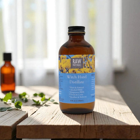 Alcohol Free Witch Hazel Distillate Face Toner in 8oz amber glass bottle on wooden table with blurred background.