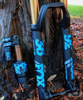 Heritage Decal Kit For Fox Forks And Shocks Dope Look Colorful Durable Sticker Set on black forks and shocks, leaned on tree.