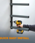 Man installing Must Have 4 Level Lumber Storage Rack For Garage Wall Mount Heavy Duty Metal Shelf in black gray finish.