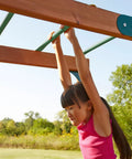 Child playing on Metal Monkey Bars Set With Six 21.5 Inch Rungs, Includes Hardware, Built Tough For Backyard Swing Sets, Green Steel Ladder
