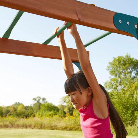 Child playing on Metal Monkey Bars Set With Six 21.5 Inch Rungs, Includes Hardware, Built Tough For Backyard Swing Sets, Green Steel Ladder