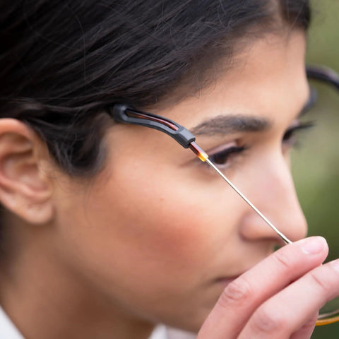 Close-up of Gecko Grip Temple Tip Sleeves for Glasses in use, showing non-slip black sleeve on thin eyeglass arm.