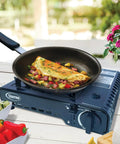 Portable Butane Stove With Ten Thousand BTU Single Burner For Indoor And Outdoor Cooking with omelet pan on top
