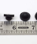 Push In Ridged SBR Rubber Bumper Foot Black, 9/16 Inch Diameter, 1/8 Inch Height, Fits 9/32 Inch Hole, placed next to ruler