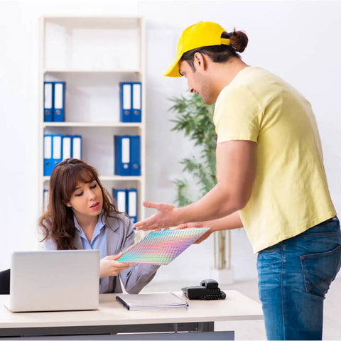 Person delivering 50 Pack Holographic Bubble Mailers Self Seal Waterproof Poly Padded Envelopes 5.9 x 9.6 Inches Exterior to office desk