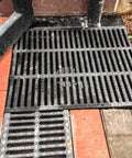 Rectangular Drainage Grate And Sewer Cover 19.7 Inch Long 11.8 Inch Wide 1.5 Inch High Tough As Nails Polymer Resin on bricks