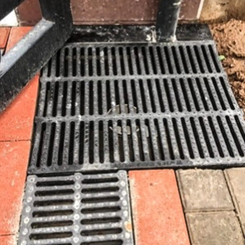 Rectangular Drainage Grate And Sewer Cover 19.7 Inch Long 11.8 Inch Wide 1.5 Inch High Tough As Nails Polymer Resin on bricks