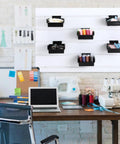 Six Piece Slatwall Bins With Hooks Set For Wall Mounted Organization in office, black bins with colorful items displayed.