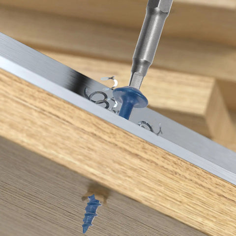 Close-up of 100 Piece Pocket Hole Screw Kit With Square Drive Drill Bit Blue Coated No 8 X 2 Inch Washer Head in wood