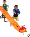 Kids playing with Six Car Super 6 Lane Raceway With 8 Foot Roll Up Track, Realistic Lights And Sounds, Includes Six 1 64 Scale Vehicles