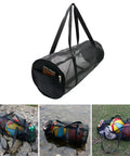 Heavy Duty Mesh Dive Bag For Gear And Sports Equipment, Foldable Duffel with sports items, rugged and ventilated design on grass and rocks.