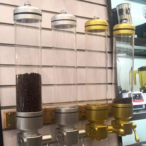 Wall Mounted Coffee Bean Dispenser With Hella Spacious Large Capacity Transparent Acrylic Jar In Slick Gold Finish For Busy Commercial Shops And Top Shelf Home Bars with coffee beans.